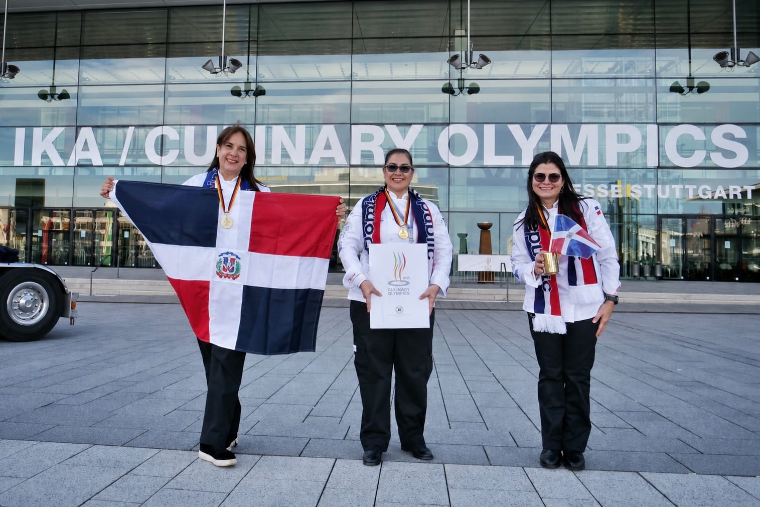 Dominican culinary team with the national flag and medals at the IKA Culinary Olympics in Stuttgart, Germany